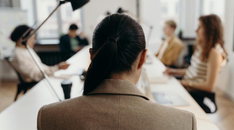 woman in brown coat sitting on chair
